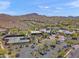 Aerial view of community amenities including a waterpark, clubhouse, tennis courts and parking lot with mountain views at 2118 W Hunter Ct # 136, Phoenix, AZ 85085