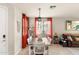 Bright dining area with modern lighting, cozy curtains, and view into the living area at 2118 W Hunter Ct # 136, Phoenix, AZ 85085