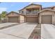 View of the three-story townhome with a tile roof, three garages, and a balcony at 2118 W Hunter Ct # 136, Phoenix, AZ 85085