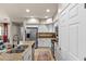 Open-concept kitchen with white cabinets, granite countertops, and stainless steel appliances overlooking the dining area at 2118 W Hunter Ct # 136, Phoenix, AZ 85085