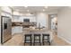 Spacious kitchen island featuring granite countertops, white cabinets, and stainless steel appliances at 2118 W Hunter Ct # 136, Phoenix, AZ 85085