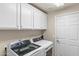 Bright laundry room equipped with modern washer and dryer units at 2118 W Hunter Ct # 136, Phoenix, AZ 85085