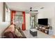 Inviting living room with a leather couch, entertainment center, and bright, natural light at 2118 W Hunter Ct # 136, Phoenix, AZ 85085