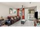 Cozy living room featuring a comfortable brown couch, large window, and access to a balcony at 2118 W Hunter Ct # 136, Phoenix, AZ 85085