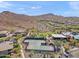 Aerial view of community tennis courts surrounded by desert landscaping, a clubhouse, and mountain views at 2118 W Hunter Ct # 136, Phoenix, AZ 85085