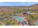 Aerial view of a community waterpark with slides and a covered picnic area surrounded by lush landscaping and mountain views at 2118 W Hunter Ct # 136, Phoenix, AZ 85085