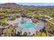 Aerial view of a community waterpark with slides and a covered picnic area surrounded by lush landscaping and mountain views at 2118 W Hunter Ct # 136, Phoenix, AZ 85085