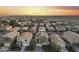 Neighborhood aerial view displays well-maintained homes and neat streets against a scenic sunset backdrop at 21407 W Hubbell St, Buckeye, AZ 85396