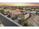 Aerial view shows a residential community with modern homes and well-kept streets, highlighting a planned neighborhood at 21407 W Hubbell St, Buckeye, AZ 85396