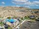 Aerial view of resort-style community pool nestled in a desert landscape with mountain views at 21407 W Hubbell St, Buckeye, AZ 85396