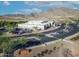 Aerial view of The Odyssey Preparatory Academy school with parking and mountain views at 21407 W Hubbell St, Buckeye, AZ 85396