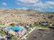 Beautiful aerial view of the community amenities surrounded by mountains, lush landscaping, and parking at 21407 W Hubbell St, Buckeye, AZ 85396