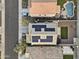 Aerial view showcases solar panels, neighborhood homes, and backyard with a pool at 21407 W Hubbell St, Buckeye, AZ 85396