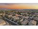 Extensive aerial perspective features a sprawling community against a sunset sky, with diverse housing styles at 21407 W Hubbell St, Buckeye, AZ 85396