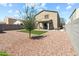 An alluring backyard featuring a synthetic lawn, desert landscaping, and a covered patio for relaxing or entertaining at 21407 W Hubbell St, Buckeye, AZ 85396