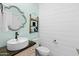 Charming powder room with stylish vanity, decorative mirror, and coastal-themed decor creating a relaxing atmosphere at 21407 W Hubbell St, Buckeye, AZ 85396