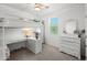 A bedroom featuring a bunk bed with a built-in desk and a matching dresser, maximizing space and functionality at 21407 W Hubbell St, Buckeye, AZ 85396