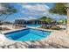 Community pool and spa features plenty of lounge seating, tables, and umbrellas for residents at 21407 W Hubbell St, Buckeye, AZ 85396