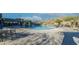 Community pool with mountain views, chairs, tables, and shade structures available for residents at 21407 W Hubbell St, Buckeye, AZ 85396