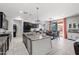 Spacious kitchen with island, granite countertops, stainless appliances, and adjacent dining area offering an open layout at 21407 W Hubbell St, Buckeye, AZ 85396