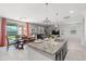 Bright, open-concept space connecting the kitchen island, dining area, and living room, ideal for entertaining at 21407 W Hubbell St, Buckeye, AZ 85396