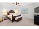 Spacious main bedroom with a king bed, bench, and a ceiling fan providing comfort and style at 21407 W Hubbell St, Buckeye, AZ 85396