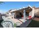 Backyard with a covered patio, brick pavers, outdoor seating, and lush landscaping at 2181 E 27Th Ave, Apache Junction, AZ 85119