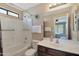 Well-lit bathroom featuring a shower-tub, a large mirror, and ample counter space at 2181 E 27Th Ave, Apache Junction, AZ 85119