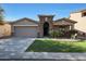Charming single-story home featuring a well-maintained lawn and a two-car garage at 2181 E 27Th Ave, Apache Junction, AZ 85119