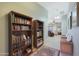 Hallway with bookshelves leading to living room and natural light at 2181 E 27Th Ave, Apache Junction, AZ 85119