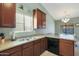 Traditional kitchen features wood cabinets and stainless steel sink at 2181 E 27Th Ave, Apache Junction, AZ 85119