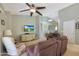 Inviting living room features plush seating, ceiling fan, and media center at 2181 E 27Th Ave, Apache Junction, AZ 85119