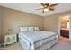Comfortable primary bedroom with a ceiling fan and an ensuite bathroom at 2181 E 27Th Ave, Apache Junction, AZ 85119