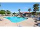 Sparkling community pool with comfortable lounge seating and shady umbrellas for residents to enjoy at 2181 E 27Th Ave, Apache Junction, AZ 85119