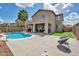 Spacious backyard with a refreshing pool, palm tree, and a cozy seating area perfect for relaxing at 2210 W Goldmine Mountain Dr, Queen Creek, AZ 85144
