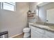 This is a cozy bathroom with a decorative shelf, granite counters, and tile flooring at 2210 W Goldmine Mountain Dr, Queen Creek, AZ 85144