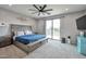 Primary bedroom features neutral decor and a sliding glass door to a patio at 2210 W Goldmine Mountain Dr, Queen Creek, AZ 85144