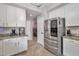 Well lit kitchen with stainless steel appliances, granite countertops, and easy access to laundry room at 2210 W Goldmine Mountain Dr, Queen Creek, AZ 85144
