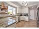 Bright kitchen featuring tile flooring, granite countertops, and stainless appliances at 2210 W Goldmine Mountain Dr, Queen Creek, AZ 85144
