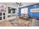 Comfortable living room features modern fireplace and blue accent wall at 2210 W Goldmine Mountain Dr, Queen Creek, AZ 85144