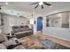 Cozy living room with comfortable sofa and open archways to kitchen at 2210 W Goldmine Mountain Dr, Queen Creek, AZ 85144