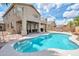 Backyard oasis with a sparkling pool, covered patio, and second story balcony for entertaining guests at 2210 W Goldmine Mountain Dr, Queen Creek, AZ 85144