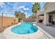Inviting backyard pool area featuring a curvaceous pool design with a covered grill area at 2210 W Goldmine Mountain Dr, Queen Creek, AZ 85144