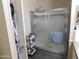 Bathroom featuring a sliding glass shower door and convenient shelving at 2400 E Baseline Ave # 153, Apache Junction, AZ 85119