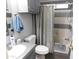 Bathroom featuring tiled walls, shower with curtain, toilet, and sink with cabinets below at 2400 E Baseline Ave # 153, Apache Junction, AZ 85119