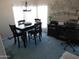 Cozy dining room with dark wood table and chairs, complemented by natural light and an office space at 2400 E Baseline Ave # 153, Apache Junction, AZ 85119