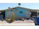 Charming single-story home featuring a desert landscape, blue exterior, and covered parking at 2400 E Baseline Ave # 153, Apache Junction, AZ 85119