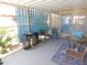 A covered patio area with a table, chairs, rug, and screened walls for outdoor relaxing at 2400 E Baseline Ave # 153, Apache Junction, AZ 85119