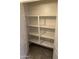 Well-organized closet with shelving for optimal storage, featuring neutral wall paint and tile flooring at 2402 E 5Th St # 1428, Tempe, AZ 85288