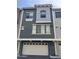 Stylish townhome featuring multi-tone exterior and well-lit two-car garage at 2402 E 5Th St # 1428, Tempe, AZ 85288